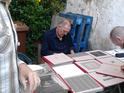 Bill Drummond signing records at the Curfew Tower